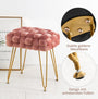sitzbank mit goldener metallbasis und rosa gepolstertem sitz